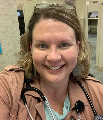 Julie Bekius smiling with a stethoscope around her neck